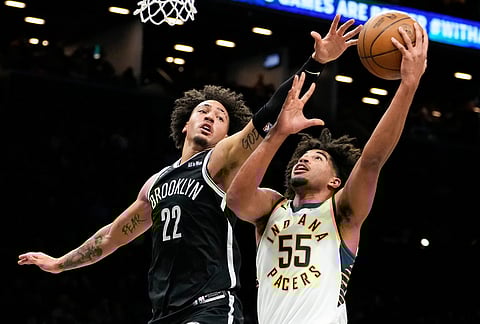 Indiana Pacers guard Ethan Thompson (55) shoots over Brooklyn Nets forward Jalen Wilson (22) during the first half of an NBA basketball game, in New York.