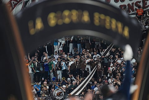 Fans of Argentina's Platense cheer prior to the start of a Copa Libertadores Group E soccer match against Brazil's Corinthians in Buenos Aires, Argentina.