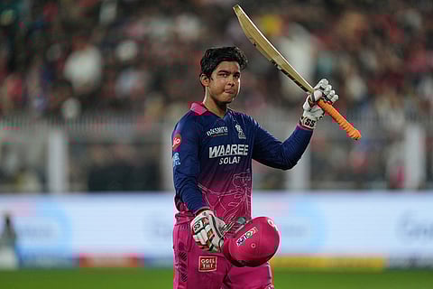 Rajasthan Royals' Vaibhav Sooryavanshi waves his bat as he leaves the ground after losing his wicket during the Indian Premier League cricket match between Royal Challengers Bengaluru and Rajasthan Royals in Guwahati, India.