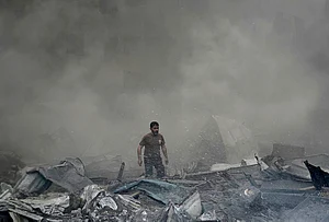 | Photo: AP/Bilal Hussein : A first responder emerges through the smoke at the site of an Israeli airstrike that struck an apartment building in Beirut, Lebanon, Wednesday, April 8, 2026.
