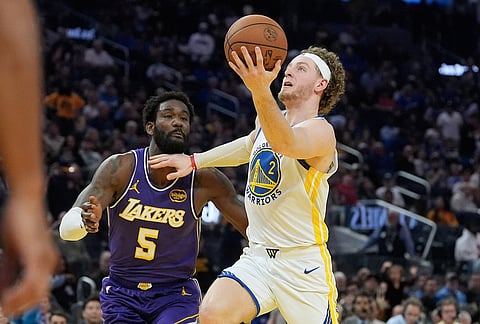Golden State Warriors guard Brandin Podziemski (2) shoots against Los Angeles Lakers center Deandre Ayton (5) during the second half of an NBA basketball game in San Francisco.