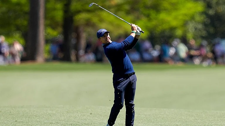 Rory McIlroy, of Northern Ireland, hits from the fairway on the 15th hole during the first round of the Masters golf tournament at the Augusta National Golf Club. - AP/David J. Phillip
