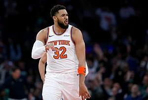 | Photo: AP/John Munson : New York Knicks center Karl-Anthony Towns reacts after making a 3-point basket during the second half of an NBA basketball game against the Boston Celtics in New York.