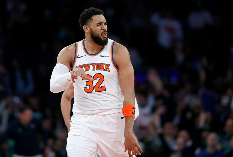 New York Knicks center Karl-Anthony Towns reacts after making a 3-point basket during the second half of an NBA basketball game against the Boston Celtics in New York. - | Photo: AP/John Munson