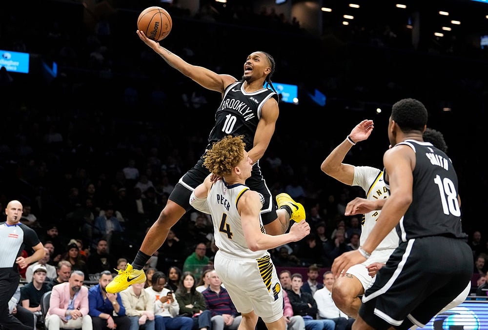 Brooklyn Nets guard Tyson Etienne (10) goes up to shoot over Indiana Pacers guard Taelon Peter (4) during the second half of an NBA basketball game in New York.  - | Photo: AP/Yuki Iwamura