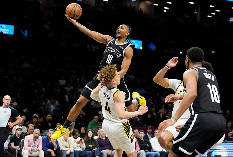 Brooklyn Nets guard Tyson Etienne (10) goes up to shoot over Indiana Pacers guard Taelon Peter (4) during the second half of an NBA basketball game in New York. - | Photo: AP/Yuki Iwamura