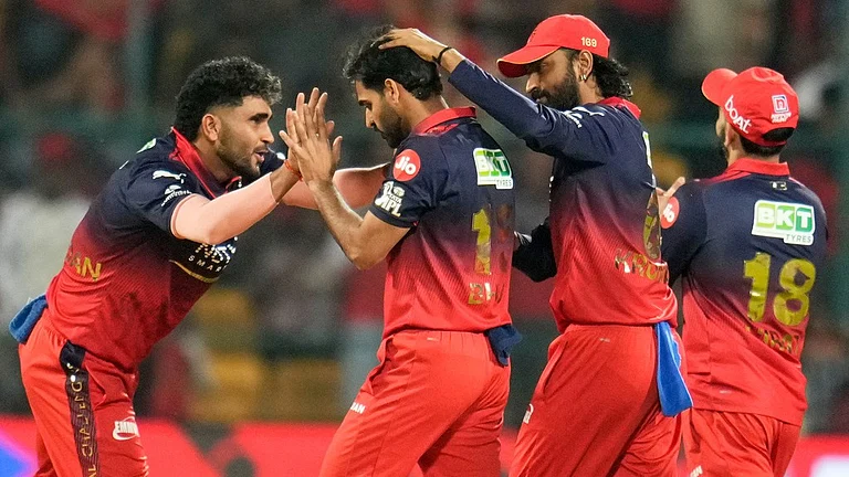 Royal Challengers Bengaluru's Bhuvneshwar Kumar, second left, celebrates with teammates the wicket of Chennai Super Kings' Ayush Mhatre during their Indian Premier League match in Bengaluru. - Aijaz Rahi