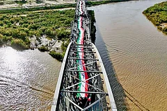 | Courtesy: X : ‘We Defend Iran With our Lives’: The people of Ahvaz form a human chain on the city’s old bridge standing firm against any attack by Trump.