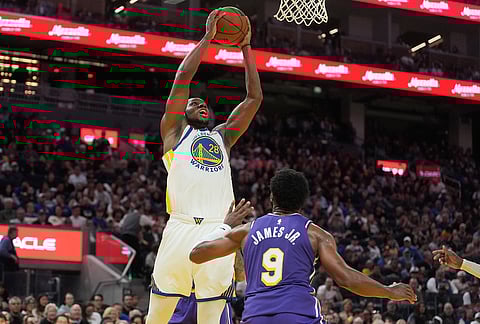 Golden State Warriors forward Charles Bassey (28) dunks against Los Angeles Lakers guard Bronny James (9) during the second half of an NBA basketball game in San Francisco.