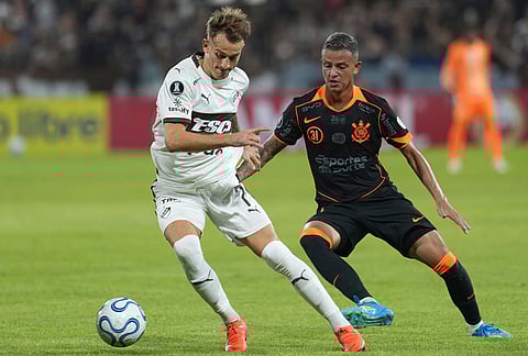 Guido Mainero of Argentina's Platense, left, and Kayke Ferrari of Brazil's Corinthians vie for the ball during a Copa Libertadores Group E soccer match in Buenos Aires, Argentina.