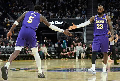 Los Angeles Lakers center Deandre Ayton (5) celebrates with forward LeBron James (23) during the second half of an NBA basketball game against the Golden State Warriors in San Francisco.