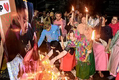 People light candles as they pay tribute to the two children who were recently killed in the Bishnupur bomb attack, in Imphal, Manipur, late Thursday, April 9, 2026. 