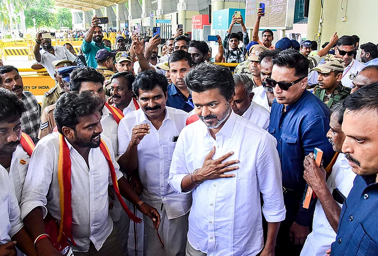 Actor and Tamilaga Vettri Kazhagam (TVK) chief Vijay being greeted by supporters upon his arrival at the airport, before heading to Karaikudi for an election campaign ahead of the Tamil Nadu Assembly polls, in Madurai. - | Photo: PTI