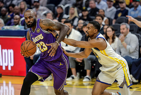 De'Anthony Melton (8) defends against LeBron James (23) in the first half as the Golden State Warriors played the Los Angeles Lakers in San Francisco.