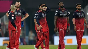 AP/Anupam Nath : Royal Challengers Bengaluru's Virat Kohli and others leave the field after being defeated by the Rajasthan Royals during their Indian Premier League match in Guwahati.