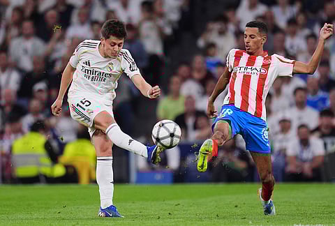 Real Madrid's Arda Guler, left, fights for the ball with Girona's Azzedine Ounahi during a Spanish La Liga soccer match between Real Madrid and Girona in Madrid, Spain.