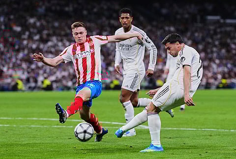 Real Madrid's Brahim Diaz, right, tries a shot during a Spanish La Liga soccer match between Real Madrid and Girona in Madrid, Spain.