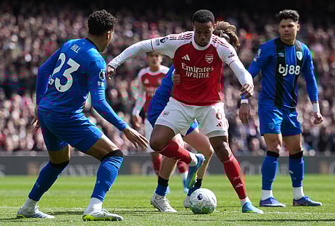 Bournemouth's James Hill guards Arsenal's Gabriel during the Premier League soccer match between Arsenal and Bournemouth in London, England.