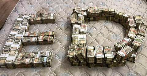 Cash seized by ED during a raid against an insolvent real estate company is displayed, in New Delhi. 