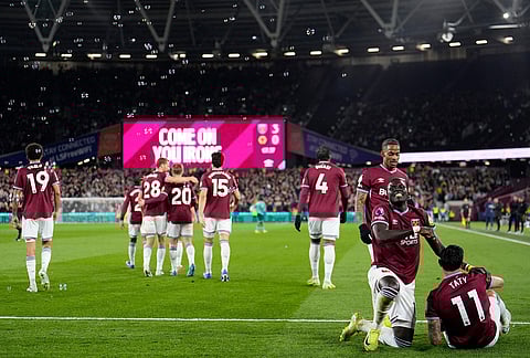 West Ham United's Taty Castellanos, bottom right, celebrates scoring with teammates during their English Premier League soccer match against Wolverhampton Wanderers in London.