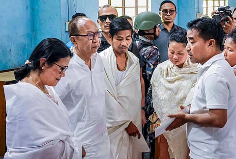 Manipur Chief Minister Yumnam Khemchand Singh, second left, meets the family members of a seven-year-old girl who was found dead under suspicious circumstances, to pay condolences during his visit to a relief camp, in Imphal, Manipur. 