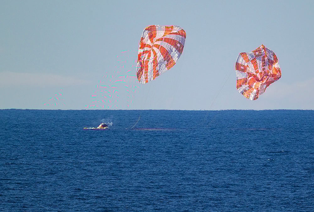 The Orion spacecraft carrying Artemis II crew members Reid Wiseman, Victor Glover, Christina Koch and Jeremy Hansen, unseen, splashes down in the Pacific Ocean off the coast of California, USA.  - | Photo:  NASA via PTI