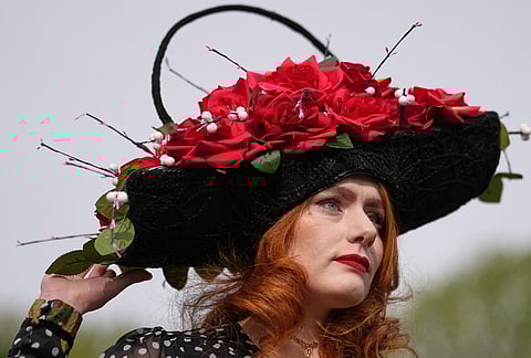 Charlotte Hawes wears a hat by House of Charles as she arrives to attend Ladies Day, the second day of the Grand National Horse Racing festival, at Aintree racecourse, near Liverpool, England.