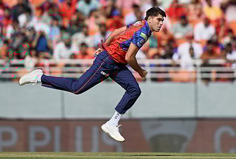 Punjab Kings' Xavier Bartlett bowls a delivery during the Indian Premier League cricket match between Punjab Kings and Sunrisers Hyderabad in New Chandigarh.
