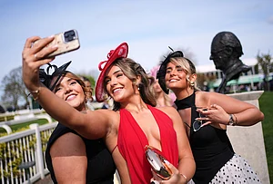 | Photo: AP/Jon Super : Racegoers take a photograph as they attend Ladies Day, the second day of the Grand National Horse Racing festival, at Aintree racecourse, near Liverpool, England.