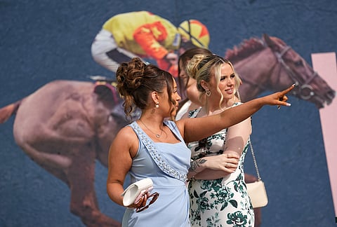 Members of the public arrive to attend Ladies Day, the second day of the Grand National Horse Racing festival, at Aintree racecourse, near Liverpool, England.