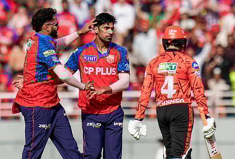 Punjab Kings' Shashank Singh, centre, with teammate celebrates after the wicket of Sunrisers Hyderabad's Travis Head during the Indian Premier League (IPL) 2026 cricket match between Punjab Kings and Sunrisers Hyderabad, at MYS Cricket Stadium in Mullanpur, New Chandigarh.
