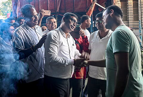 TMC candidate for Krishnanagar Uttar constituency, Somnath Dutta, centre, interacts with people during an election campaign ahead of the West Bengal Assembly Election, in Nadia district.