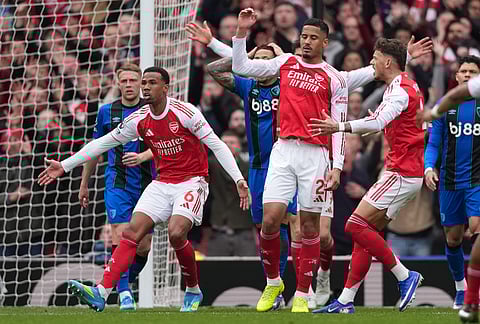 Arsenal players demand a penalty call after a hand play during the Premier League soccer match between Arsenal and Bournemouth in London, England.