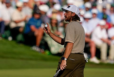 Tommy Fleetwood, of England, waves after his putt on the 16th hole during the second round of the Masters golf tournament at the Augusta National Golf Club in Augusta, Georgia. 