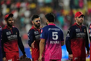 Photo: AP/Anupam Nath : Royal Challengers Bengaluru's Virat Kohli and Rajasthan Royals' captain Riyan Parag shake hands at the end of the Indian Premier League cricket match between Royal Challengers Bengaluru and Rajasthan Royals in Guwahati, India.