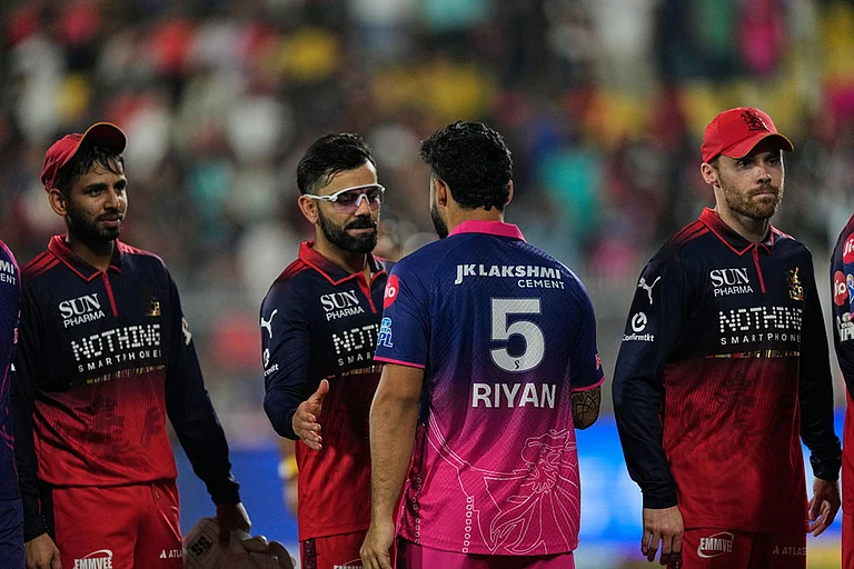 Royal Challengers Bengaluru's Virat Kohli and Rajasthan Royals' captain Riyan Parag shake hands at the end of the Indian Premier League cricket match between Royal Challengers Bengaluru and Rajasthan Royals in Guwahati, India. - Photo: AP/Anupam Nath