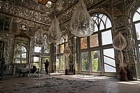 Photo: AP/Francisco Seco : Broken glass lies on the floor beneath chandeliers covered in protective plastic in a room damaged, according to Iranian authorities, by a nearby airstrike during U.S.-Israeli strikes in early March at the Golestan Palace, a UNESCO World Heritage site, in Tehran, Iran.