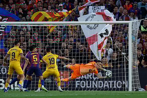 Barcelona's goalkeeper Joan Garcia makes a save during the Spanish La Liga soccer match between Barcelona and Espanyol in Barcelona, Spain.