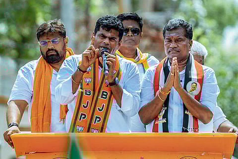 In this image posted on April 12, 2026, BJP leader K Annamalai, holding a microphone, addresses an election campaign in support of NDA candidate for Karaikudi constituency, Dherpoki V Pandi, front right, ahead of the Tamil Nadu Assembly Election, in Sivaganga district.