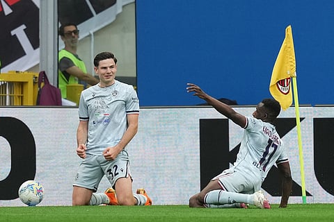 Udinese's Jurgen Ekkelenkamp, left, and Hassane Kamara celebrate after scoring during the Serie A soccer match between AC Milan and Udinese, in Milan, Italy.