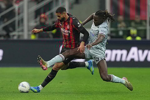 AC Milan's Ruben Loftus-Cheek, left, and Udinese's Oumar Solet fight for the ball during the Serie A soccer match between AC Milan and Udinese, in Milan, Italy.