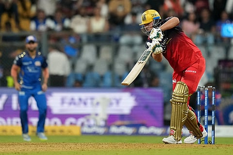 Royal Challengers Bengaluru's Tim David plays a shot during the Indian Premier League cricket match between Mumbai Indians and Royal Challengers Bengaluru, in Mumbai, India.