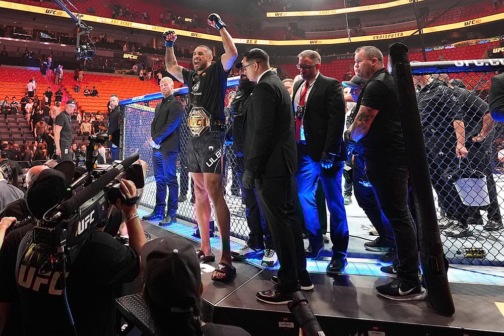 Carlos Ulberg, center left, of New Zealand, celebrates after defeating Jiri Prochazka, of Czechia, by TKO to win their light heavyweight title bout at a UFC 327 mixed martial arts event in Miami. - | Photo: AP/Rebecca Blackwell