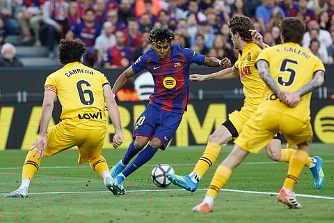Barcelona's Lamine Yamal, centre, controls the ball during the Spanish La Liga soccer match between Barcelona and Espanyol in Barcelona, Spain.