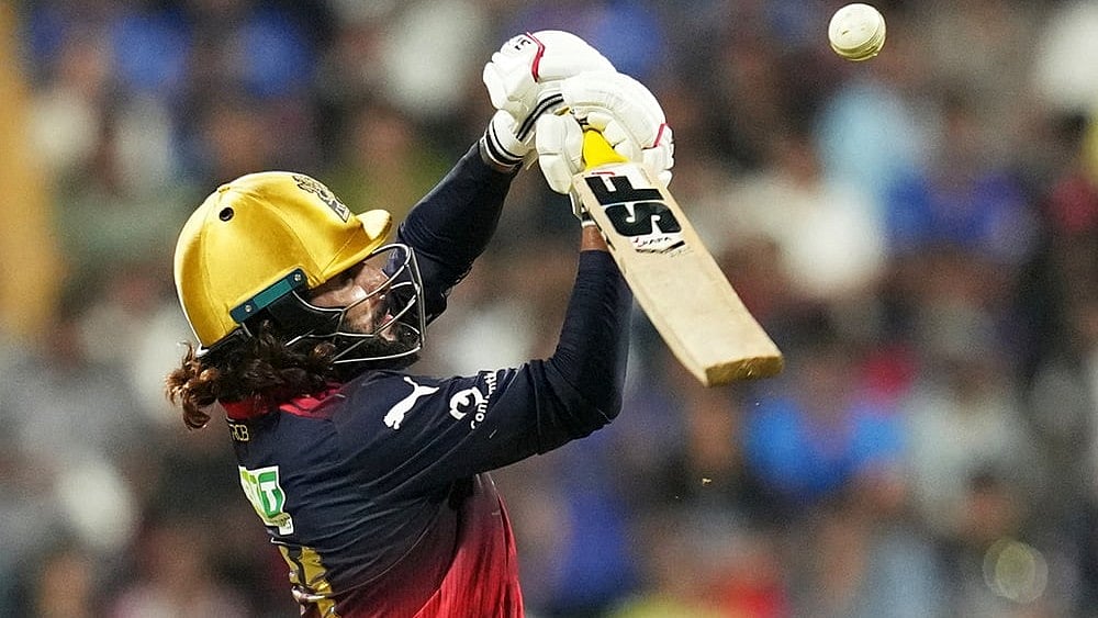 | Photo: AP/Rafiq Maqbool : Royal Challengers Bengaluru's captain Rajat Patidar plays a shot during the Indian Premier League cricket match between Mumbai Indians and Royal Challengers Bengaluru, in Mumbai, India.
