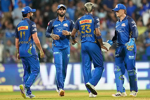 Mumbai Indians' captain Hardik Pandya, 33, and others celebrate the wicket of Royal Challengers Bengaluru's Virat Kohli during the Indian Premier League cricket match between Mumbai Indians and Royal Challengers Bengaluru, in Mumbai , India.