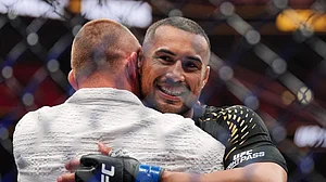 (AP Photo/Rebecca Blackwell) : Carlos Ulberg, of New Zealand, reacts after defeating Jiri Prochazka, of Czechia, by TKO to win their light heavyweight title bout at a UFC 327 mixed martial arts event, Saturday, April 11, 2026, in Miami.