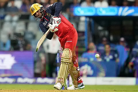 Royal Challengers Bengaluru's Jitesh Sharma plays a shot during the Indian Premier League cricket match between Mumbai Indians and Royal Challengers Bengaluru, in Mumbai, India.