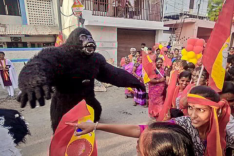 A man dressed as gorilla takes part in an election campaign by Tamilaga Vettri Kazhagam (TVK) candidate for Madurai Central constituency, VMS Mustafa, unseen, along with other party supporters ahead of the Tamil Nadu Assembly Election, in the Madurai district.