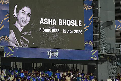 Attendees stand during a moment of silence observed in memoriam of singing legend Asha Bhosle, before an Indian Premier League (IPL) 2026 T20 cricket match between Mumbai Indians and Royal Challengers Bengaluru, in Mumbai, Maharashtra. Bhosle, India's beloved singing icon, died at the age of 92 on Sunday following multiple organ failure, doctors treating her said.